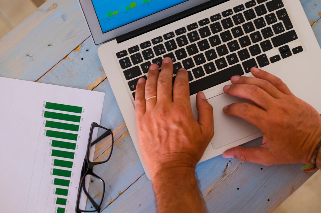 close up of hands of man on a laptop working hard to create an agency - business man